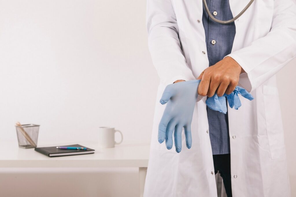 A imagem mostra um médico se preparando para fazer um exame de endoscopia.